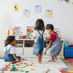 Children play in a living room full of toys