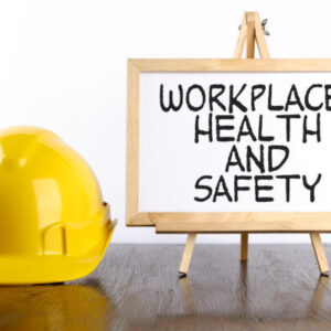 Yellow hardhat and a small sign that reads 'Workplace health and safety'